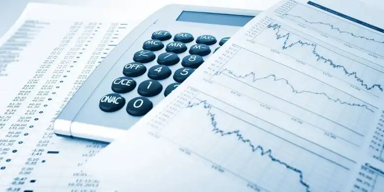 Calculator and financial charts on a desk